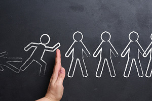 A hand stops a chain reaction of falling figures drawn in chalk, a Business Photo by ndanko