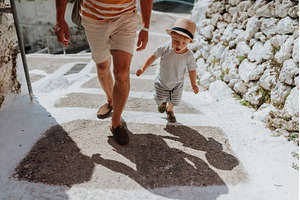 Close up on legs of father and, a Person Photo by HalfPoint