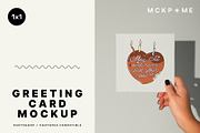 Square greeting card in hand mockup, a Merchandise Mockup by MCKP*ME (Thumbnail 1 of 5)