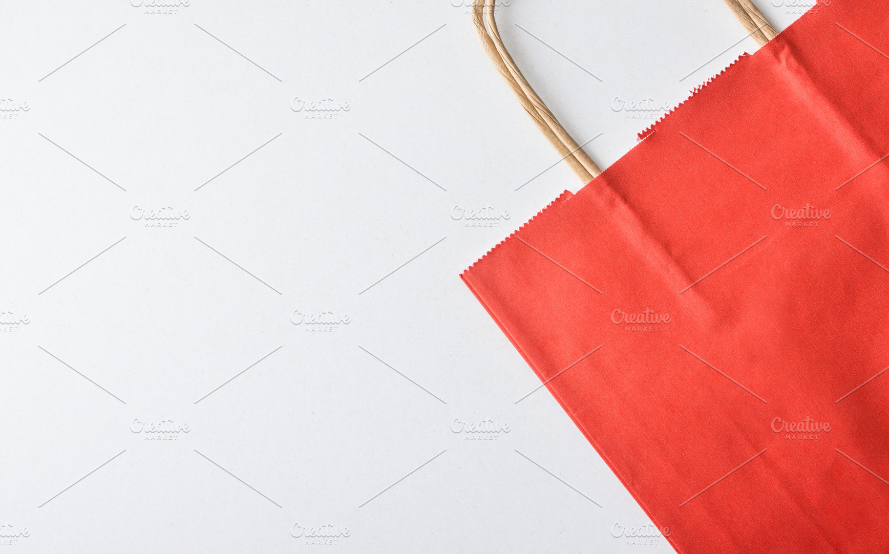Empty and folded red paper shopping bag on white, an Industrial Photo by Davizro's Market