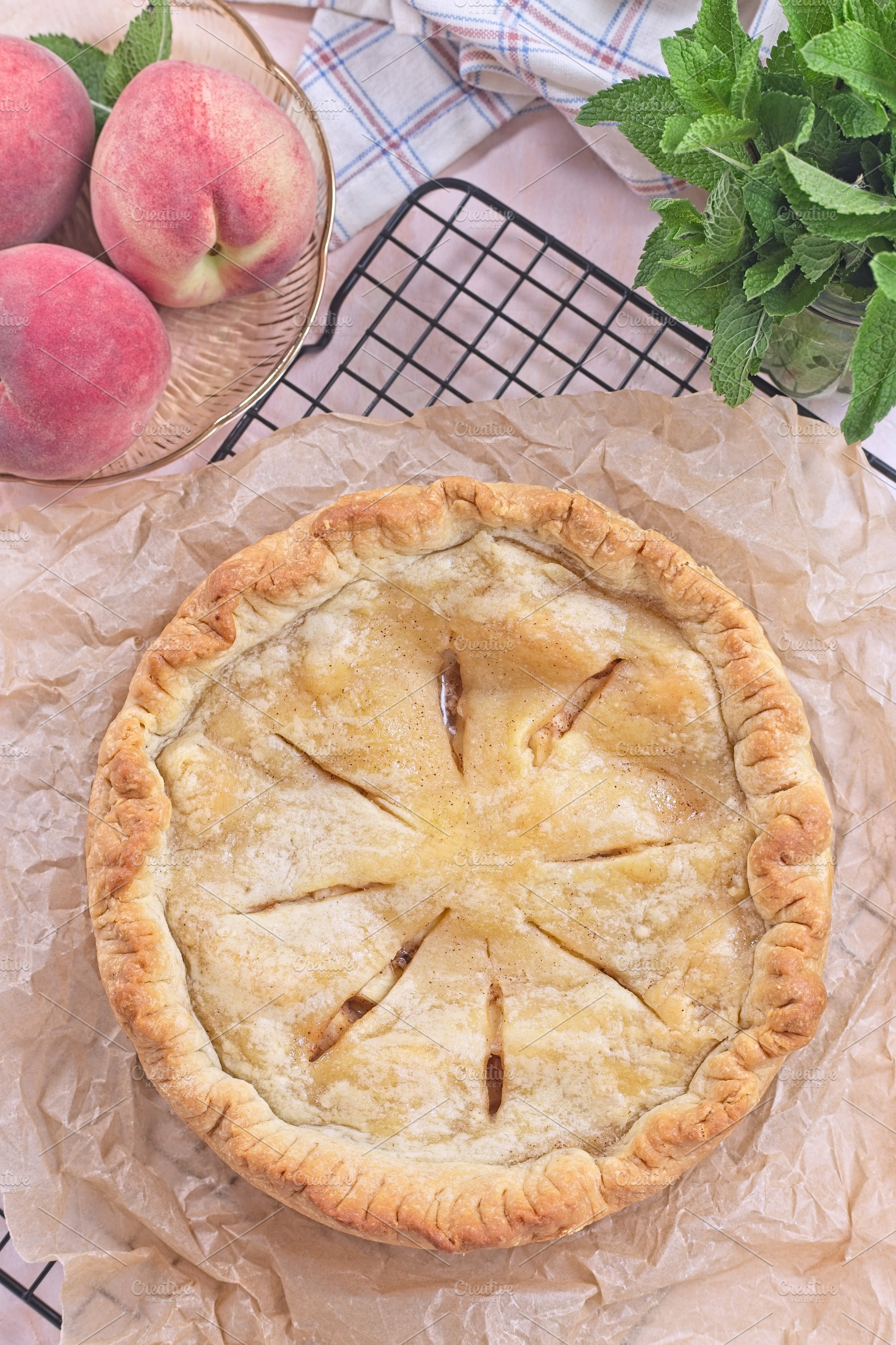 Freshly baked old fashioned deep dish peach pie cooling on baking rack, vertica, a Food & Drink Photo by iuliia_n