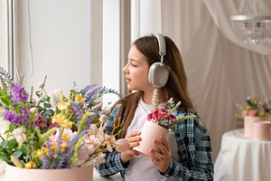 Teen girl wearing headphones holding, a Person Photo by Elena Vagengeim