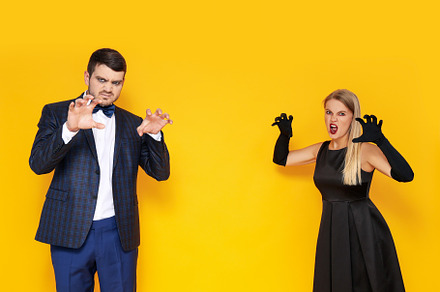 Concept of Halloween, young man and woman on yellow background, a Person Photo by AtlasStudio PRO