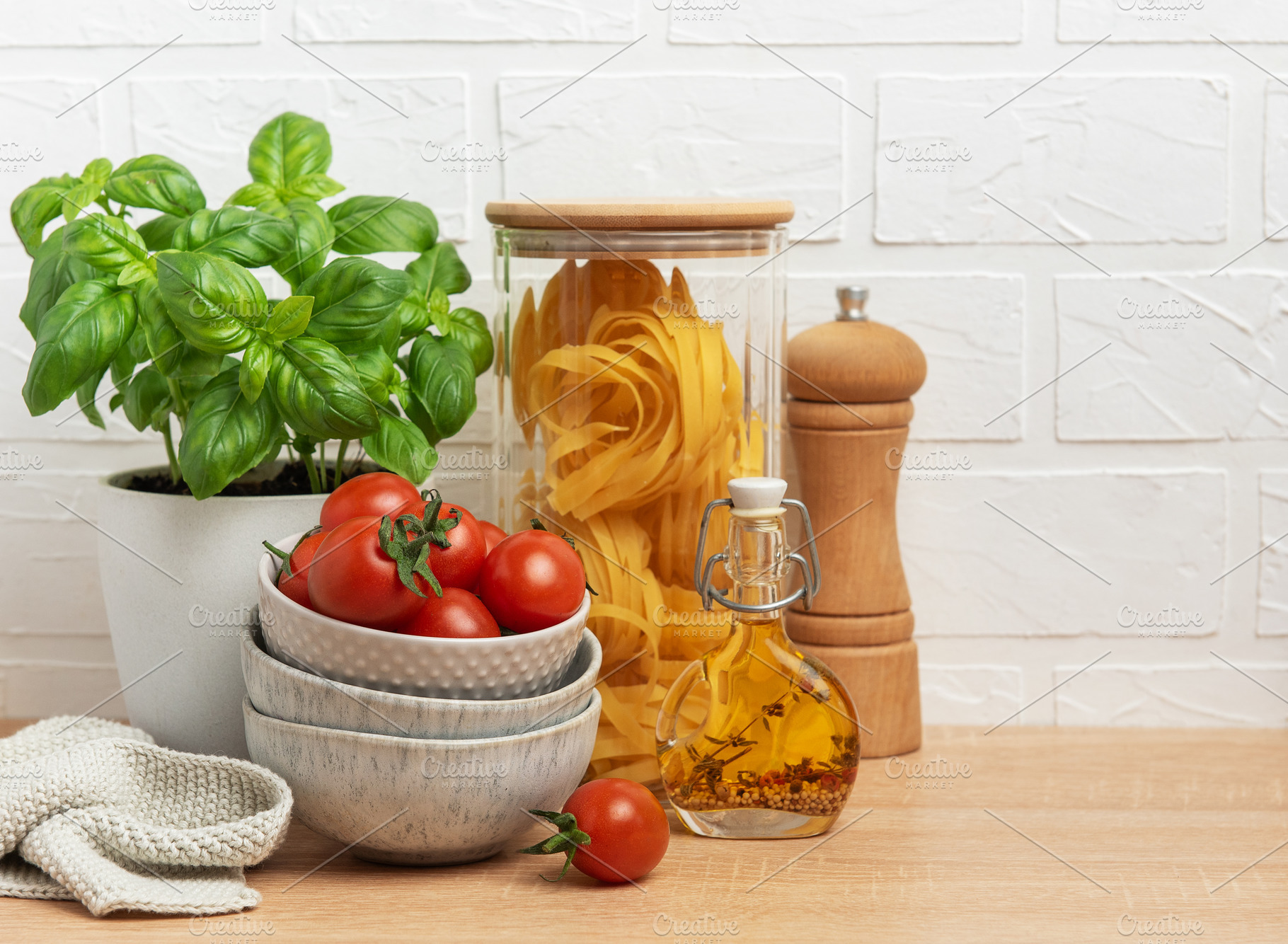 Cherry tomatoes, basil, pasta and olive oil creating an italian, a Food & Drink Photo by Olena Rudo