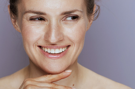 smiling modern woman on blue, a Beauty & Fashion Photo by Alliance Images
