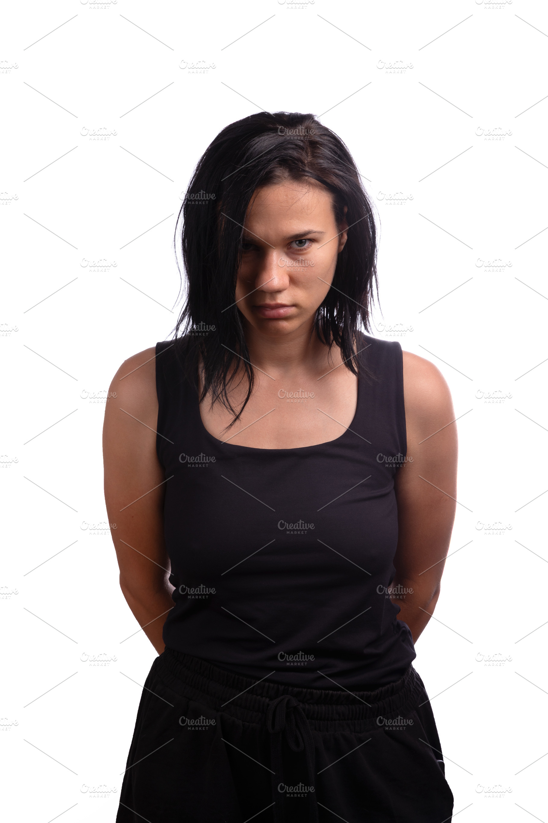Young woman with black hair in a black tank top standing against, a Person Photo by Ales Munt