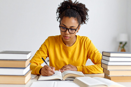 Student deeply concentrated on a book, surrounded by a calm and, a School & Education Photo by DanFLCreativo