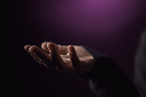Open hand reaching in darkness. Concept of poverty, inequality,, a Photo by salmon.black