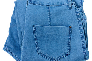 Folded pair of light blue denim jeans with visible back pocket,, a Beauty & Fashion Photo by ndanko