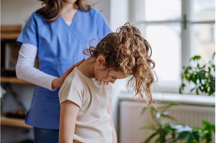 Little girl doing exercise with a, a Health & Medical Photo by HalfPoint