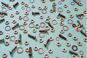 Scattered metal nuts bolts and