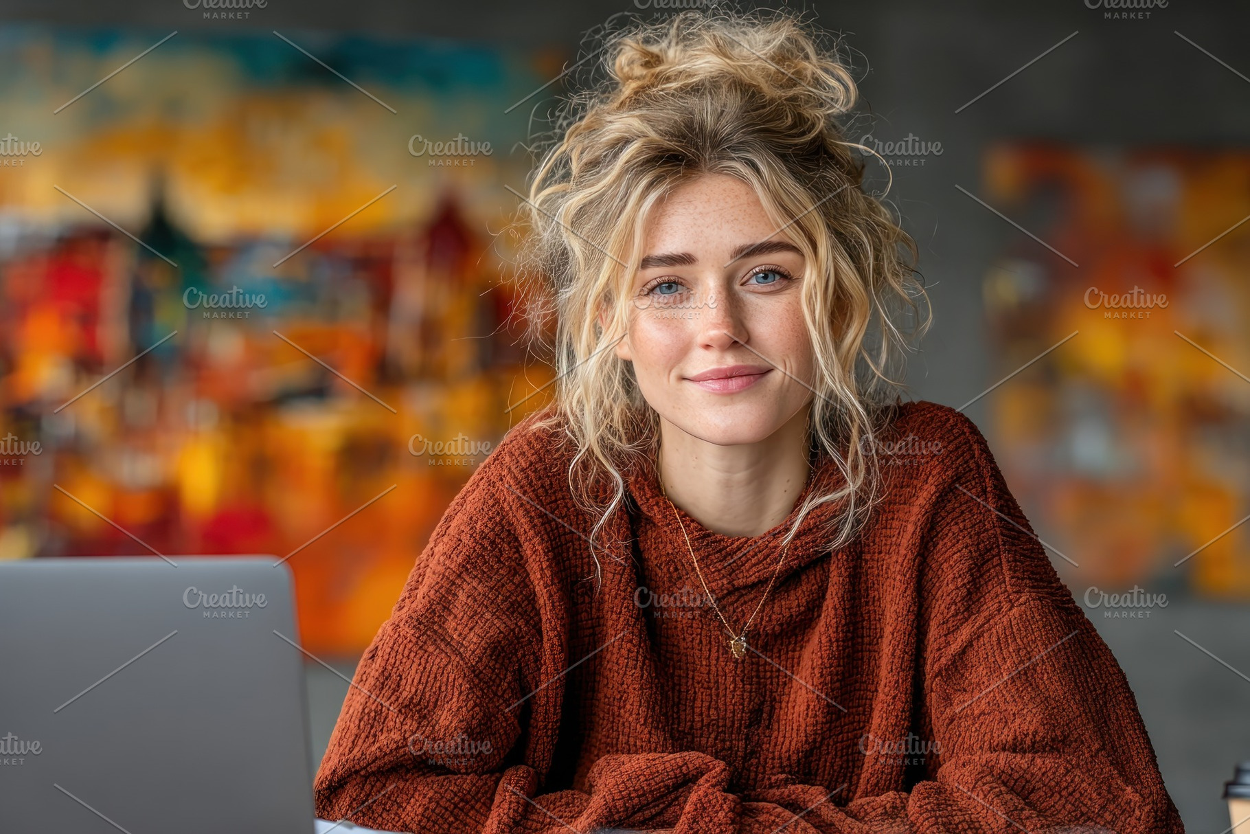 Smiling Blonde Woman Working on Laptop in Art Studio with Colorf, a Person Photo by José Manuel Gelpi