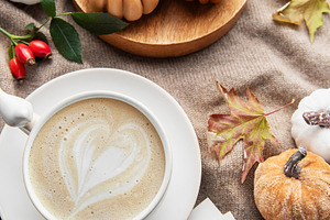 Autumn hygge flat lay with coffee and pumpkin candles