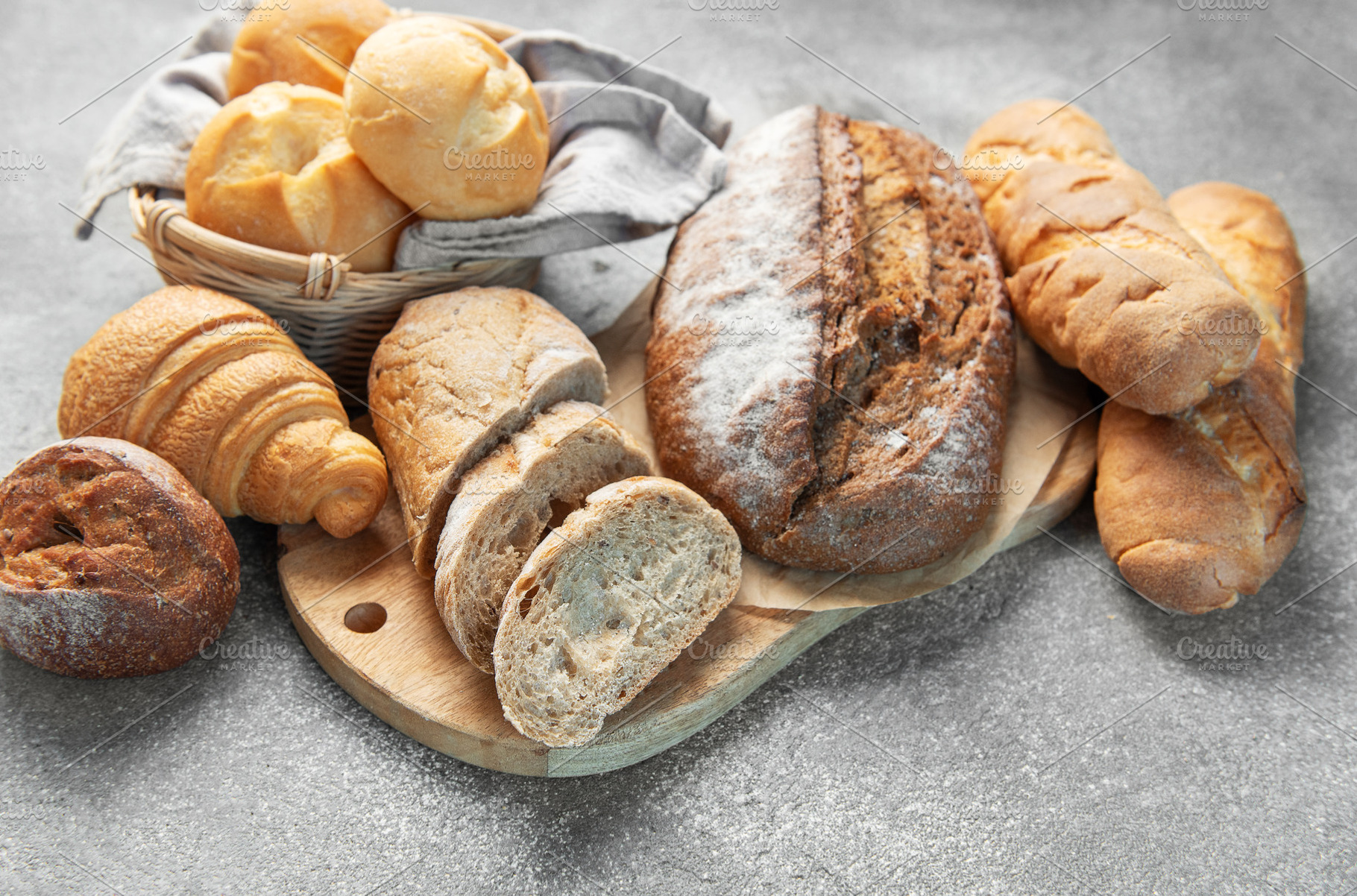 Fresh baked assorted breads and pastries on table, a Food & Drink Photo by Olena Rudo