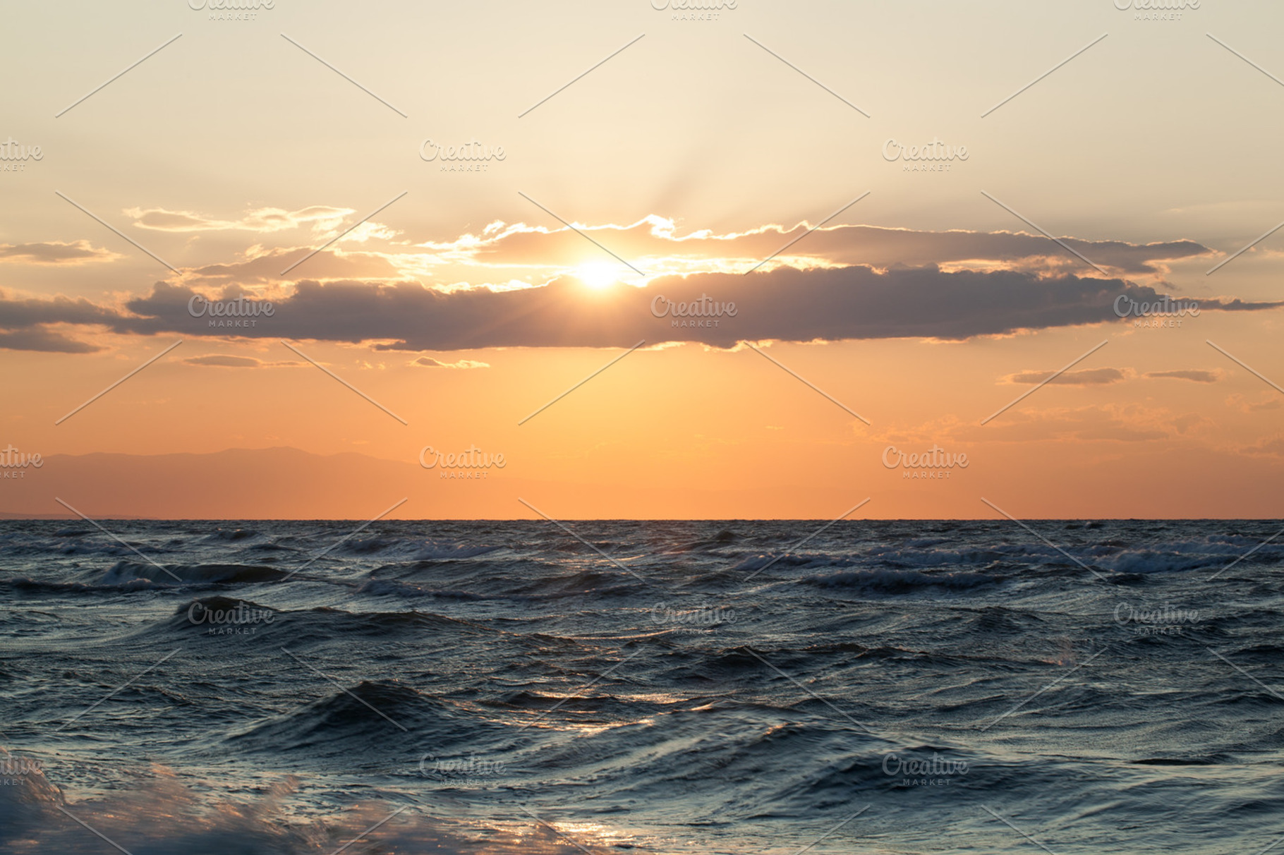 Rough sea and sunset over it containing sea, sunset, and rough, a ...