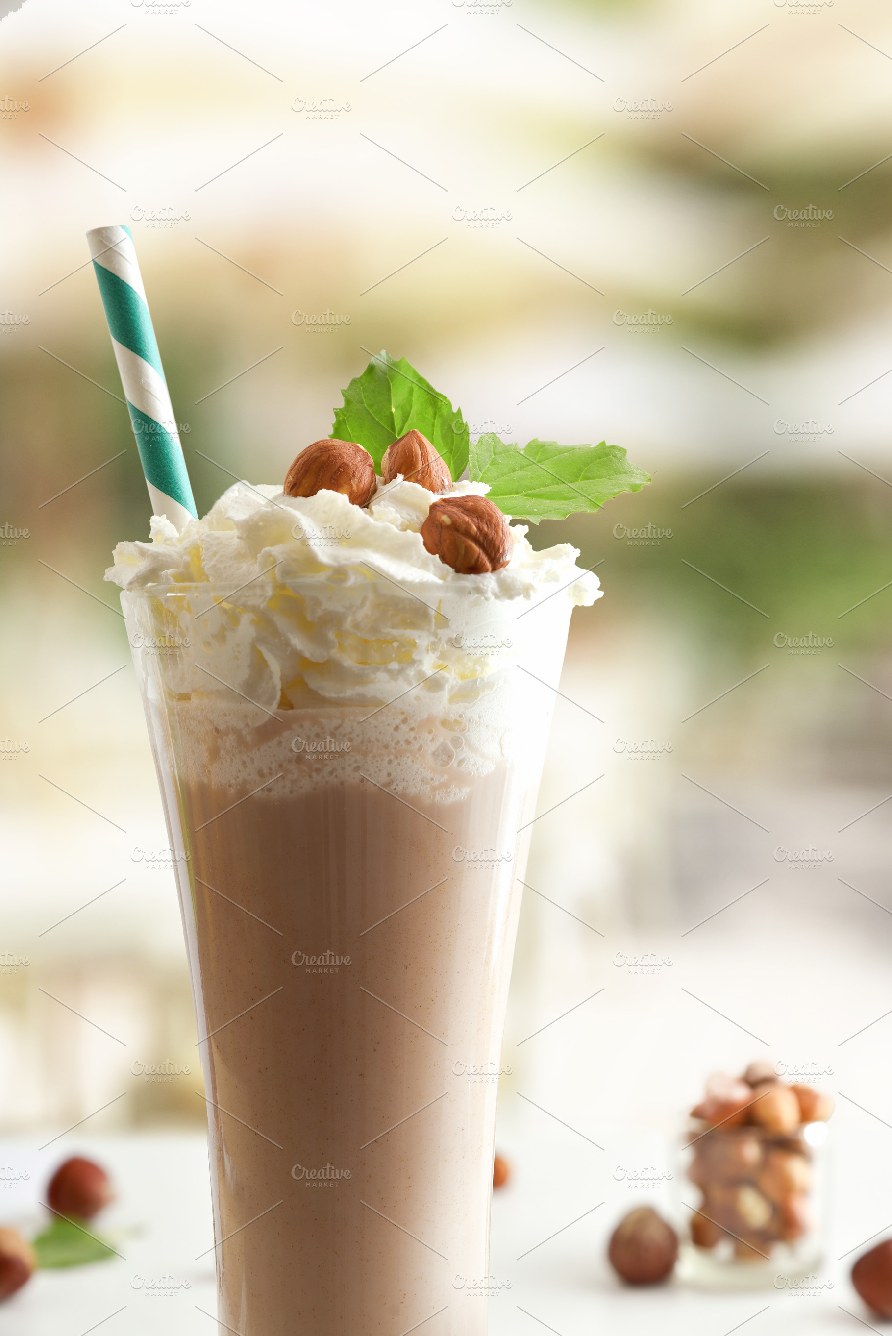 Detail of milkshake with hazelnuts and cream on a terrace, a Food & Drink Photo by Davizro's Market