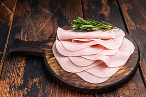 Close up of savory sliced ham showcasing its rich color and text, a Food & Drink Photo by composter-box@mail.ru