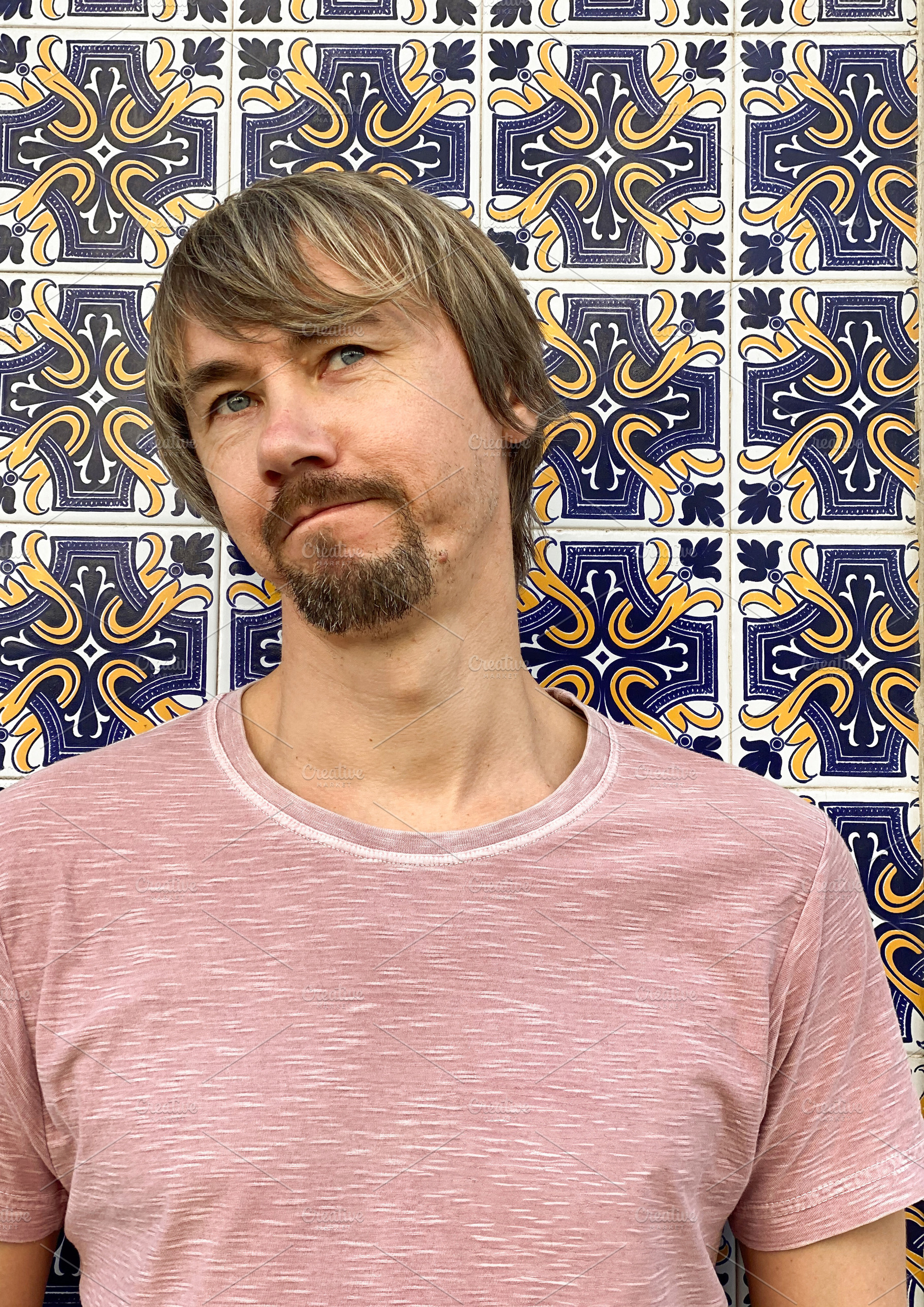 Man standing against decorative tiled wall in Lisbon, a Person Photo by sebastianaraw