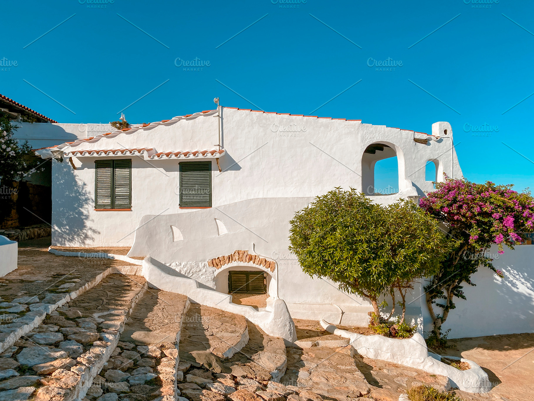 steps and white houses in La Almadrava, Spain, a Photo by Nito