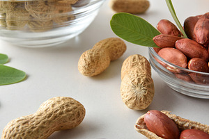 Detail of peeled peanuts in glass bowl on a white table, a Food & Drink Photo by Davizro's Market