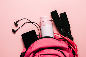 Sports bag and accessories on pink b
