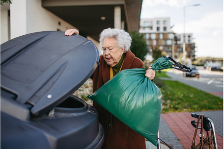 Elderly woman disposing of trash, an Architecture Photo by HalfPoint