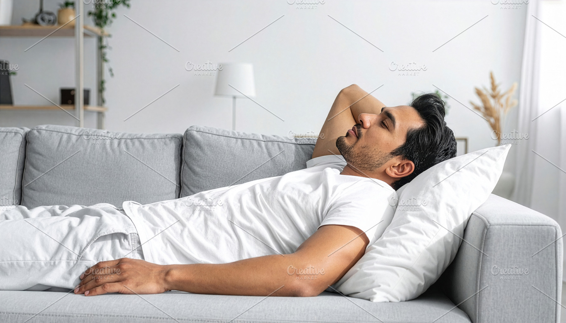 Young Man Resting on Comfortable Living Room Sofa, a Photo by Davizro's Market