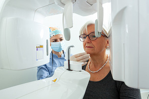 Dentist preparing elderly woman for dental x ray in clinic, a Photo by Antonio Gravante Market