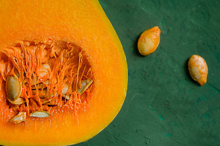 Small pumpkins on green background