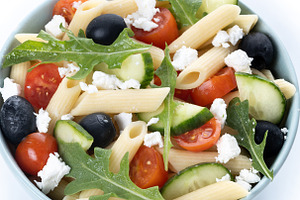 Mediterranean Pasta Salad in bowl with Fresh Vegetables and Herbs isolated on w, a Food & Drink Photo by etorres69