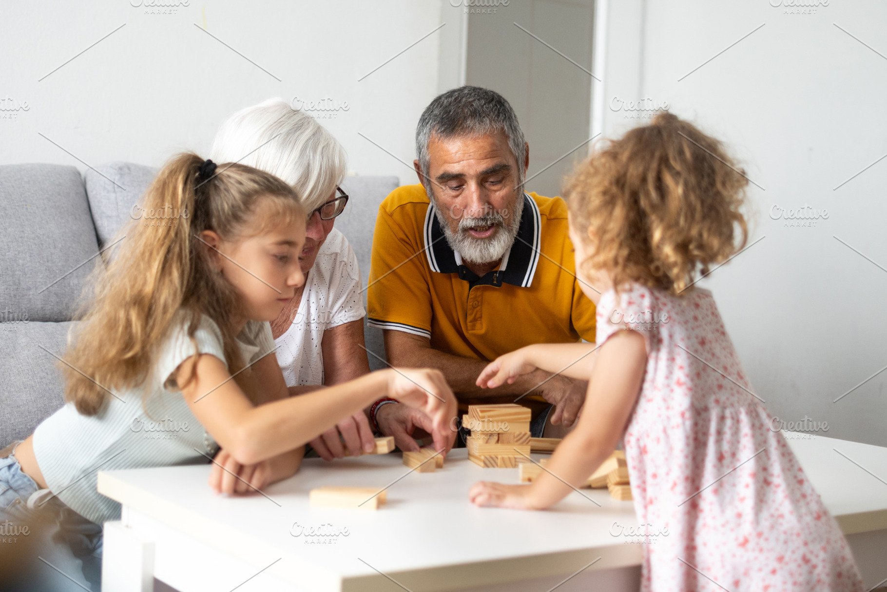 Happy grandparents playing with their granddaughters, a Photo by etorres69