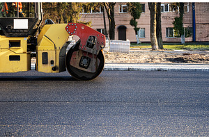 Road roller machine compacts fresh, an Industrial Photo by volodymyrshtun13795