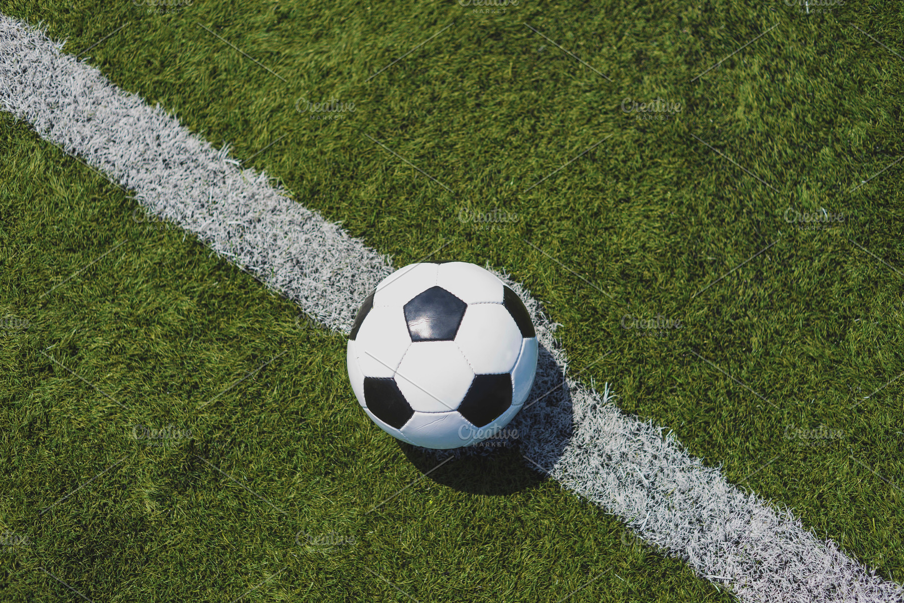 Soccer ball on green grass over the, a Sports & Recreation Photo by 2Design