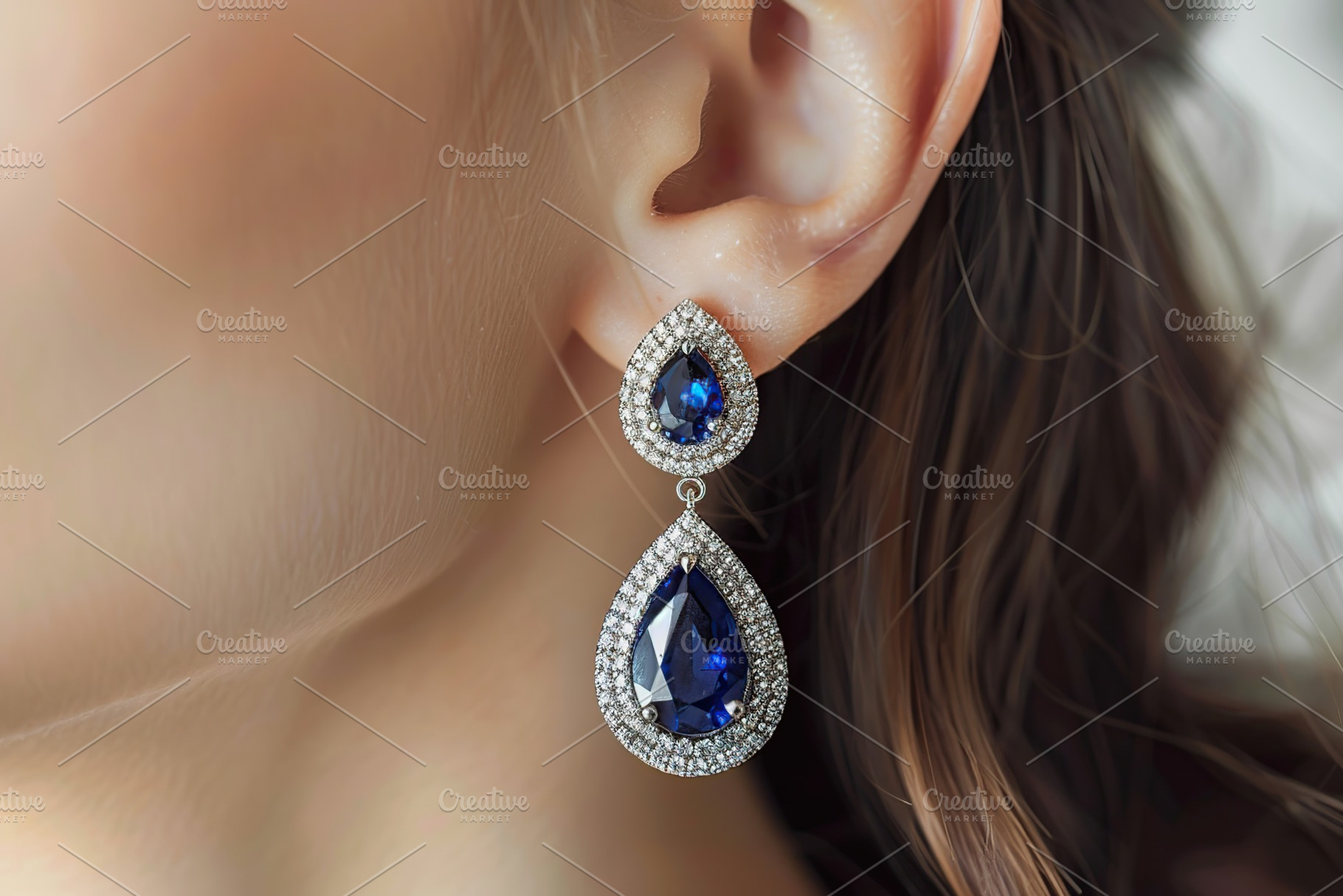 Young woman with blue sapphire earrings, a Photo by AlyaAnd