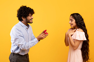 Marry me concept. Happy indian man proposing showing engagement ring box and as, a Photo by Prostock-Studio