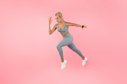 Serious woman running at pink studio background, a Photo by Prostock-Studio (Thumbnail 2 of 2)