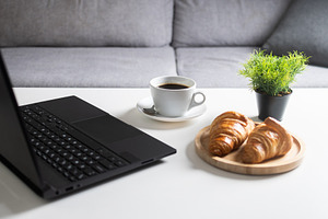 Breakfast with Coffee and Croissants on Home Office Desk, a Food & Drink Photo by etorres69