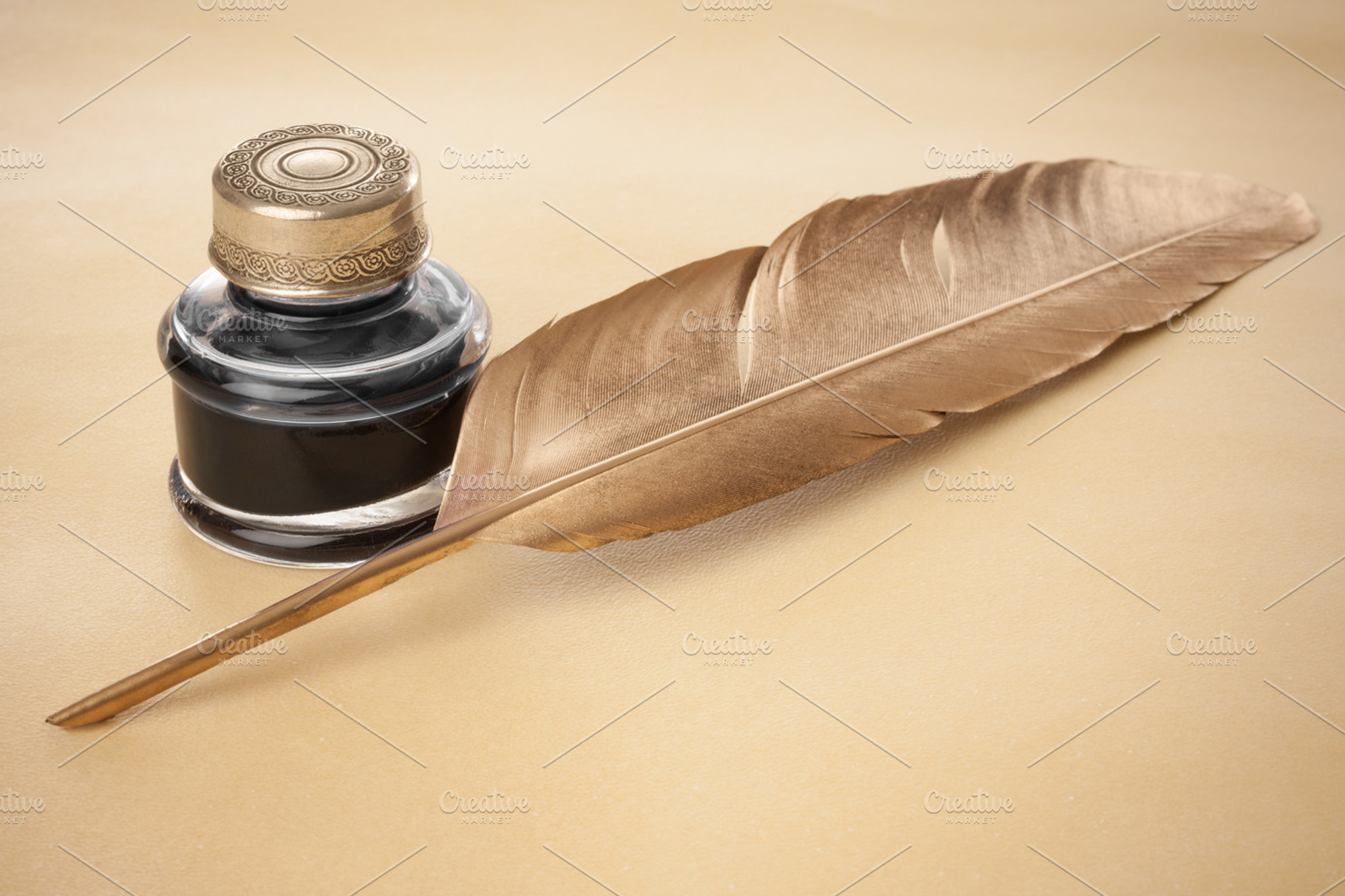 Golden quill pen on parchment, a Photo by Ernesto Solla