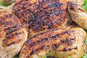 Grilled spatchcocked chicken with lemon garlic marinade, with lettuce and lemon, a Food & Drink Photo by iuliia_n