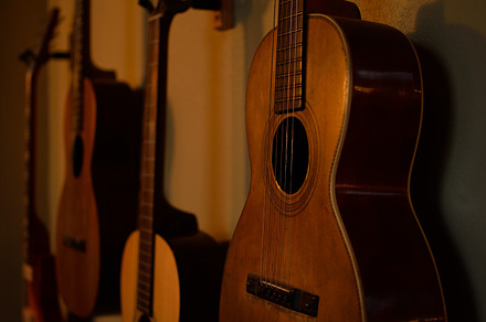 Vintage parlor guitars on wall stock photo containing parlor and guitar, an Arts & Entertainment Photo by ClubhouseArts