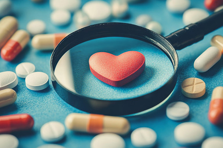 Magnifying Glass Over Heart Symbol Surrounded by Various Pills, an Abstract Photo by Natalia Klenova's Shop
