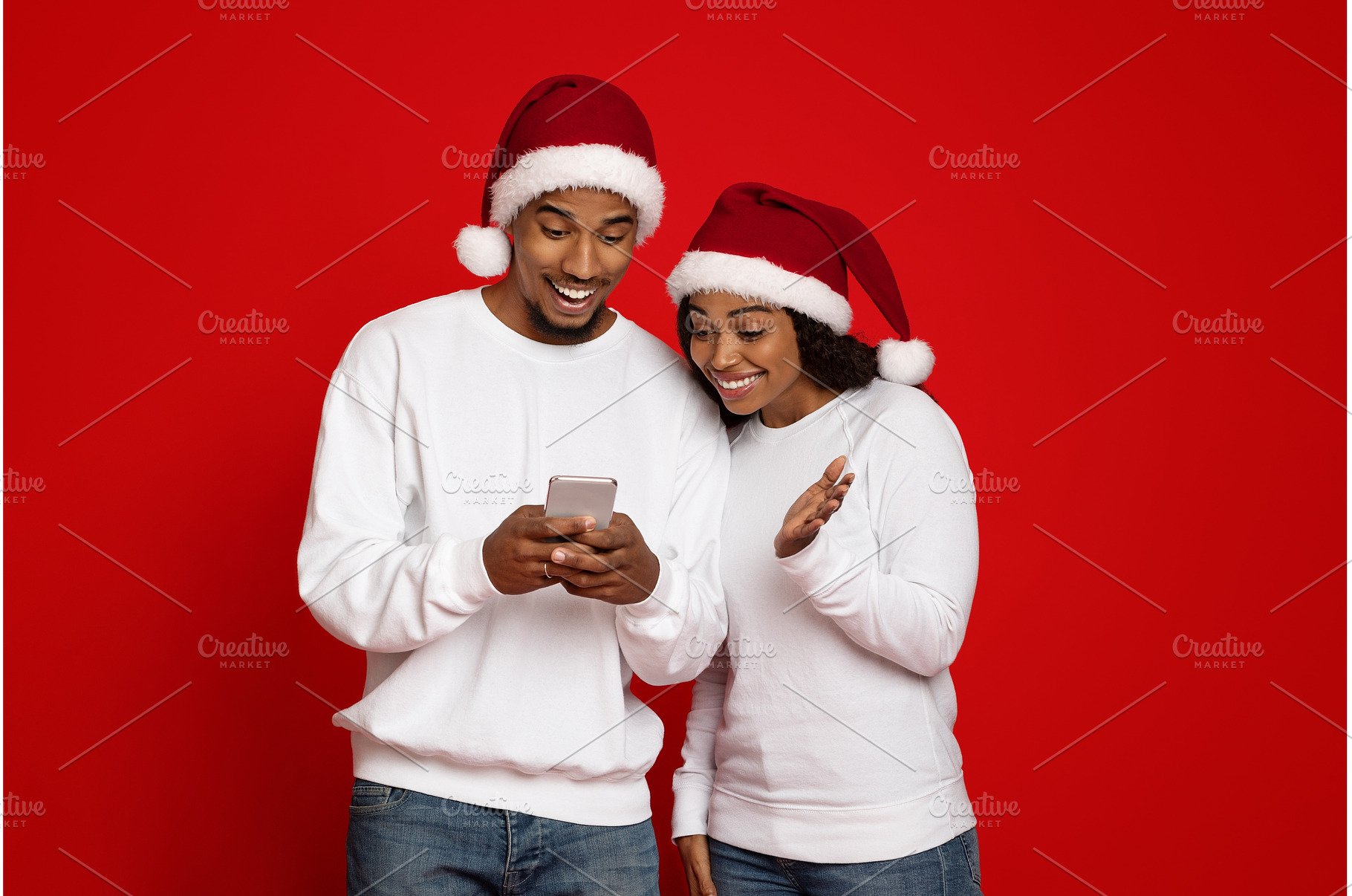Cheerful black couple in Santa hats, a Person Photo by Prostock-Studio