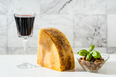 a piece of parmesan or pecorino cheese on a white table and red, a Food & Drink Photo by IriGri