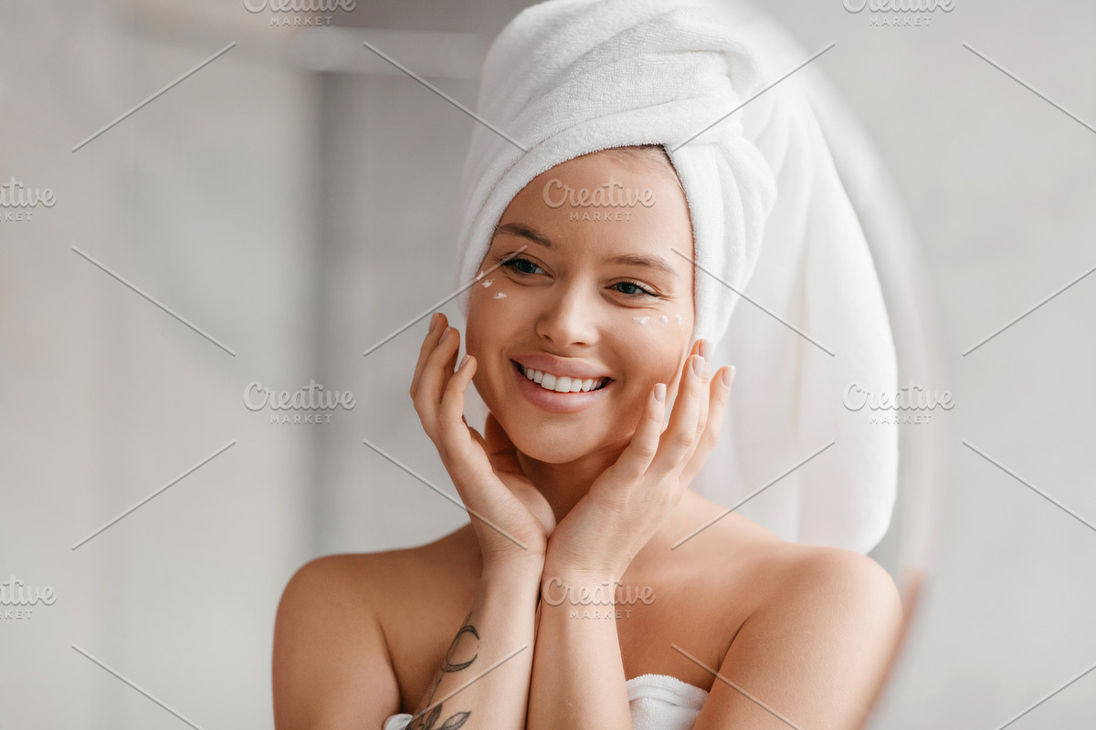 Bodycare concept. Portrait of beautiful young lady with cream on cheeks and whi, a Photo by Prostock-Studio (Photo 2 of 2)