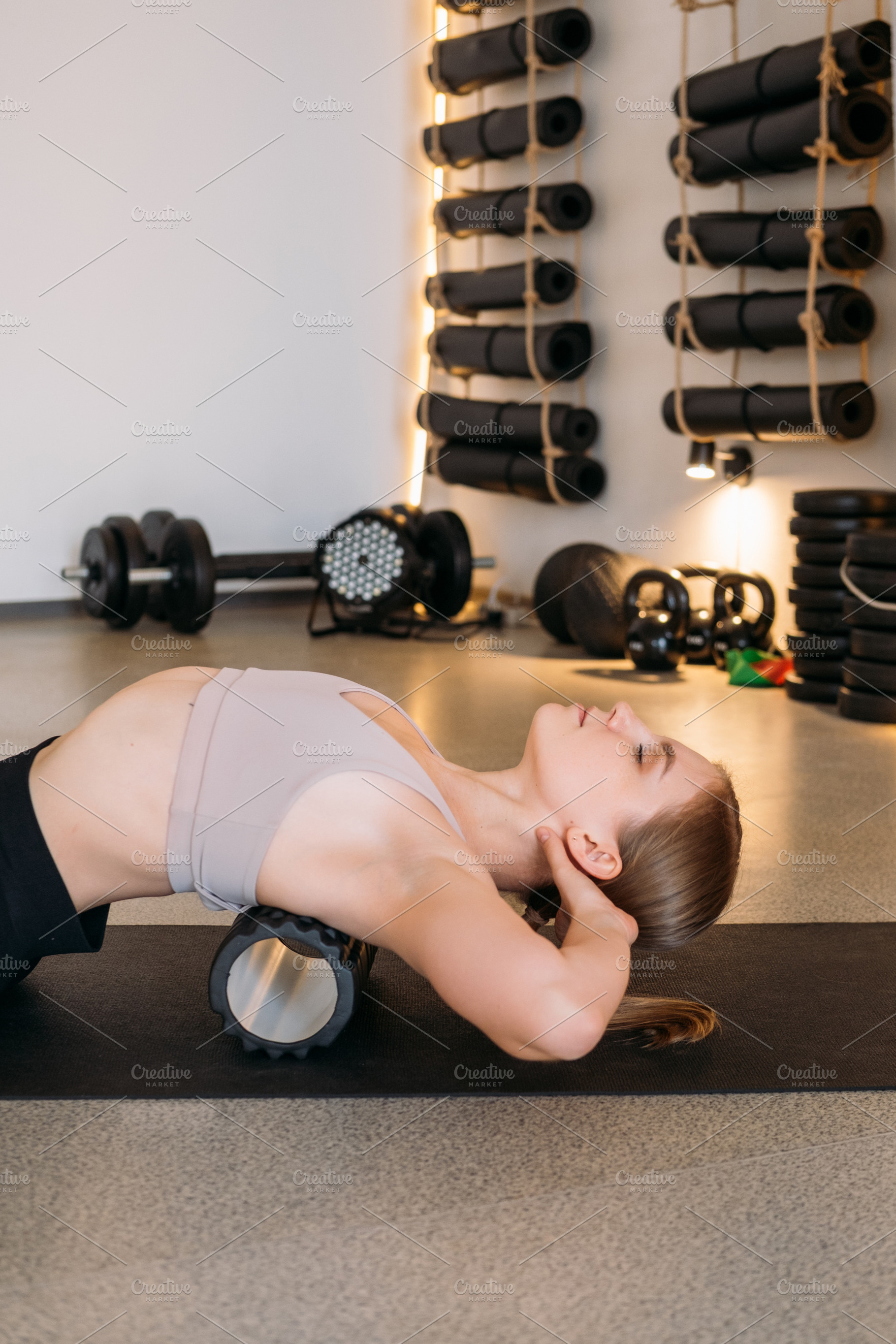 Physical therapy back massage roller female health, a Person Photo by Photo Drive Studio