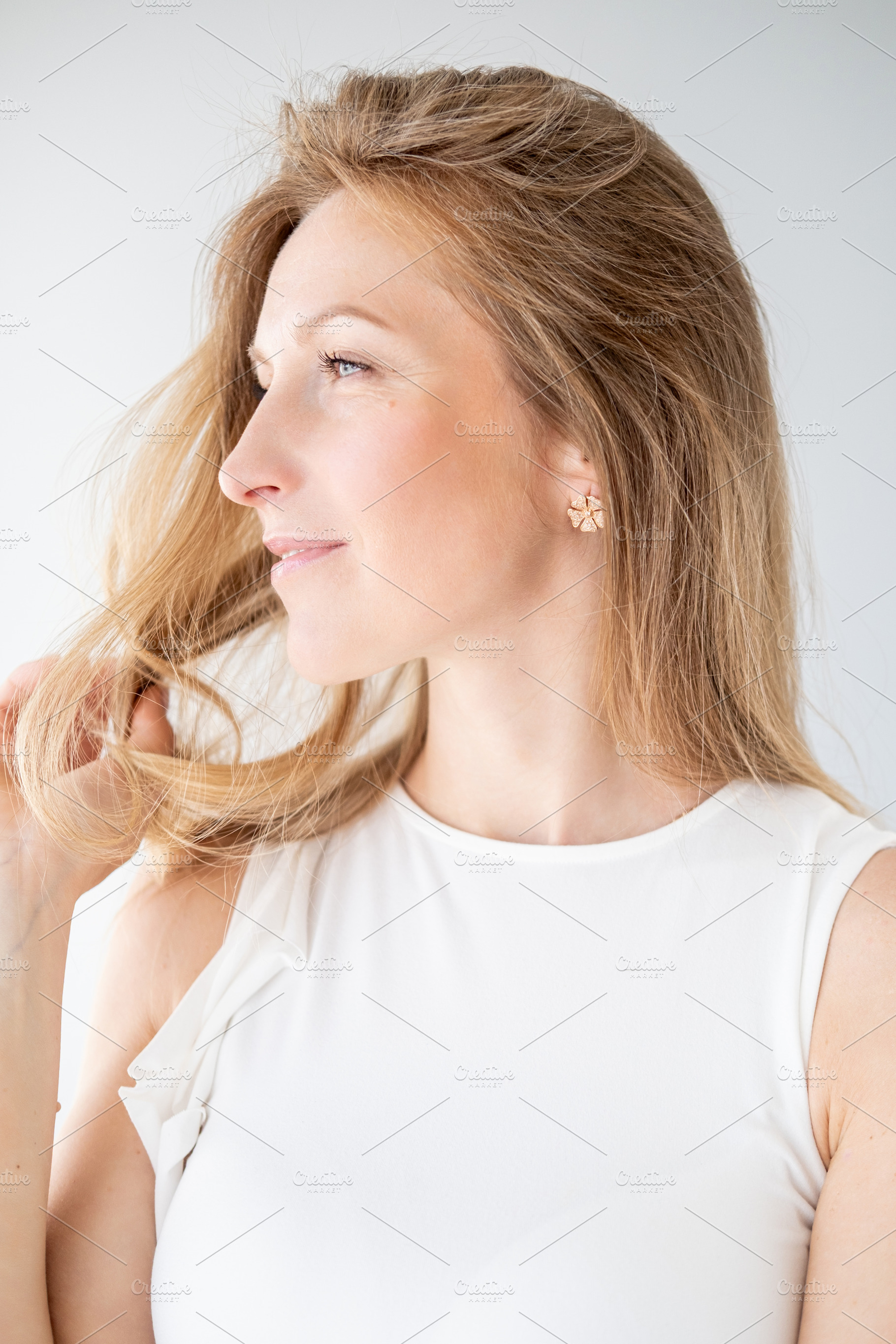 Female beauty playful relaxation woman touch hair, a Person Photo by Photo Drive Studio