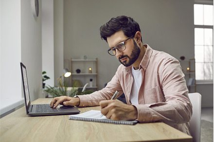 Man sitting at his desk at home, a Technology Photo by StudioRomantic