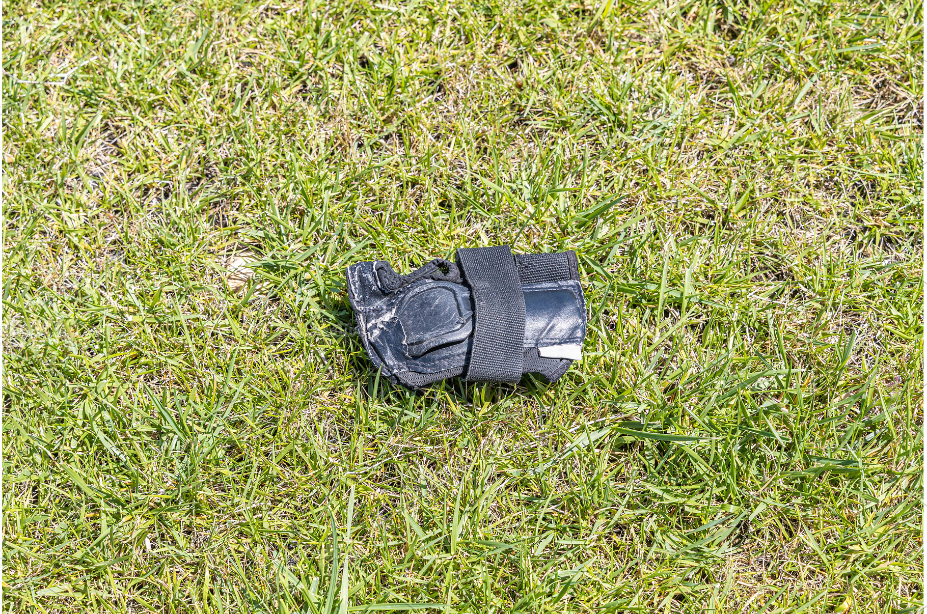 A gray wrist guard on the green, a Sports & Recreation Photo by Illustrations&photos