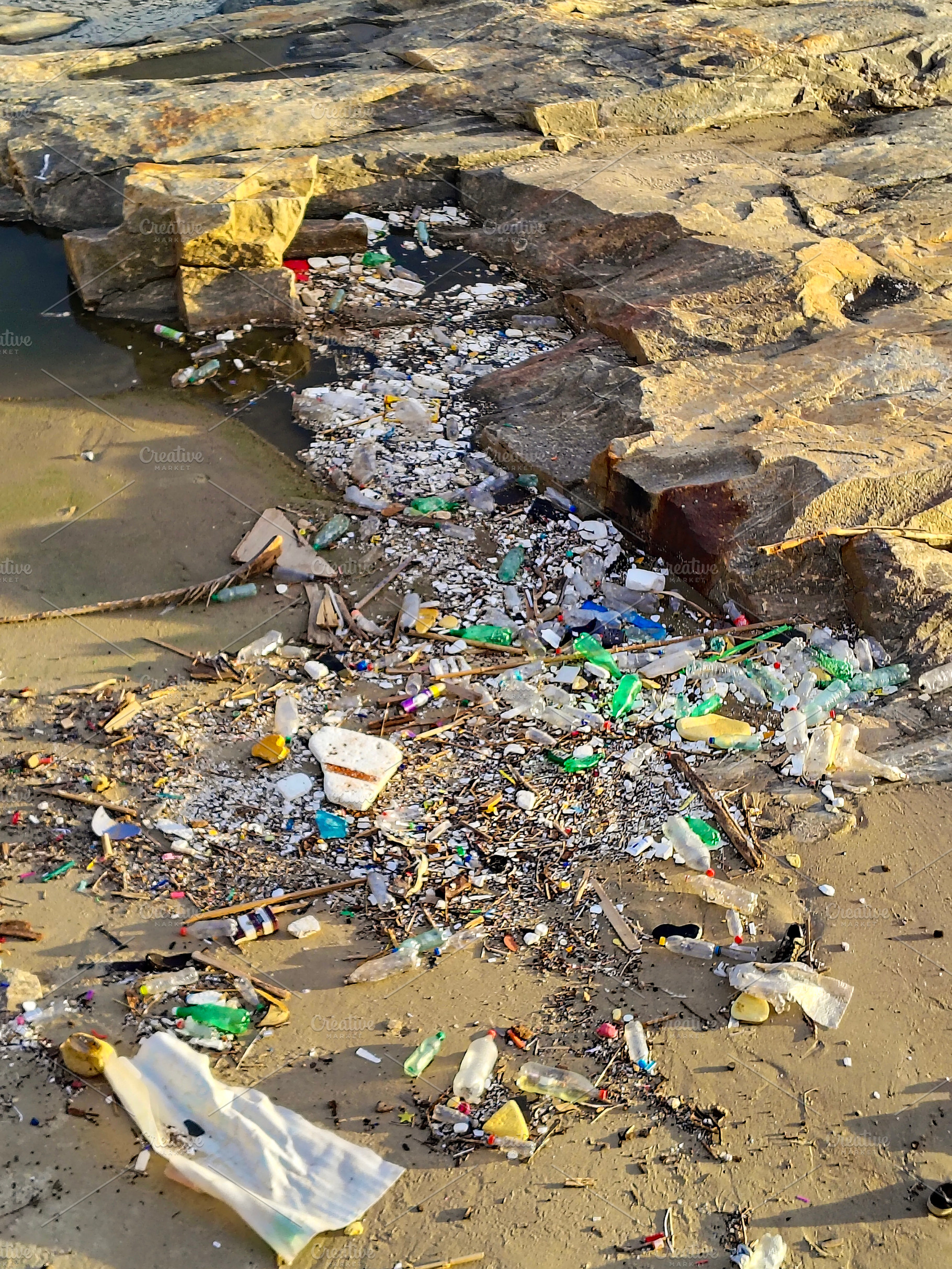 Rocky beach covered in litter, montevideo, uruguay, a Nature Photo by DanFLCreativo