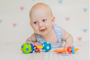Adorable baby playing with colorful, a Background Photo by Elizaveta Galitskaya